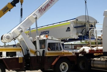 Ertech Crane lifting tray off of a truck